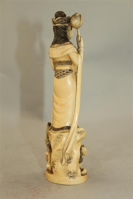 A Japanese ivory group of an immortal and a shi-shi, early 20th century, 18cm